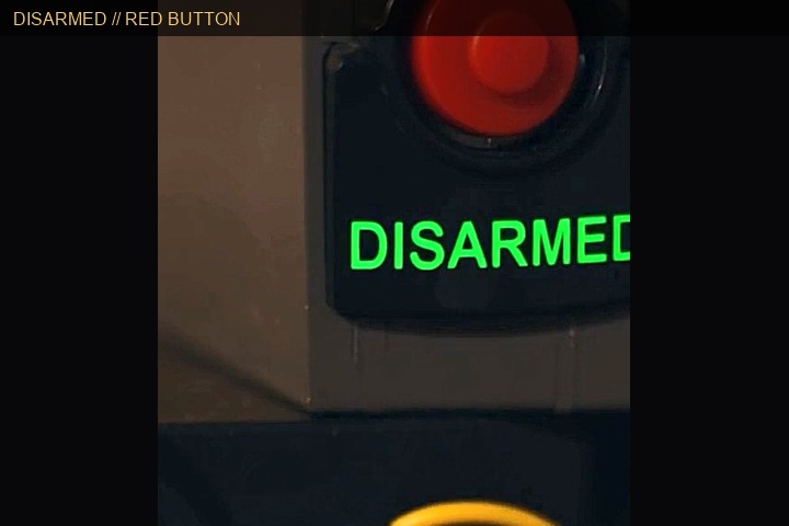 Red disable button with green DISARMED status &mdash; no wires cut