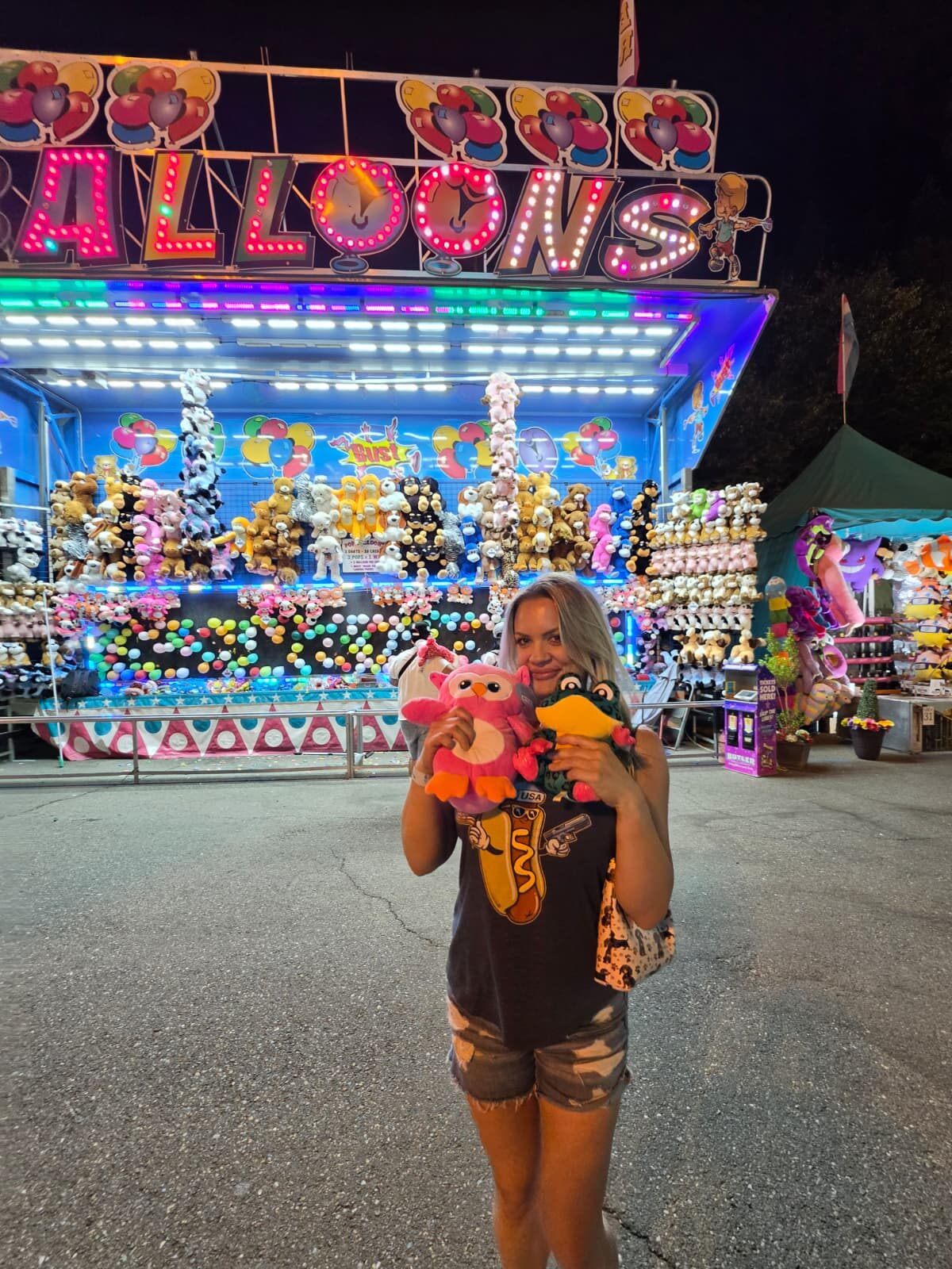 Night Shade with prizes full body in front of balloon game